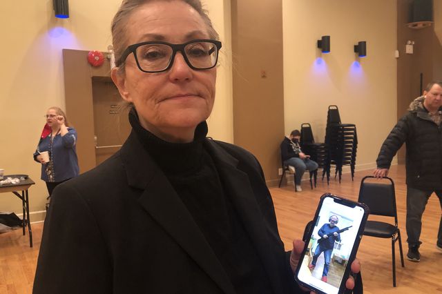 Ronya Lozynskyj showing a picture of her friend, a filmmaker who enlisted Terrestrial Defense Forces
